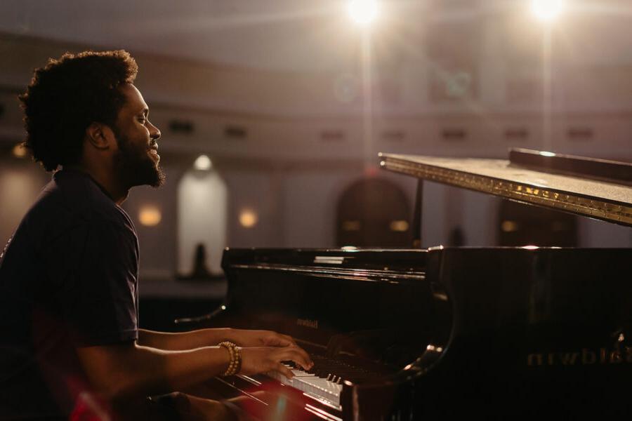 a keyboard performance major playing piano in a chapel